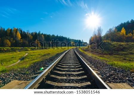  railway track in the autumn forest.Old  railway in the autumn evening