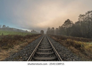 Railway track for engine unit passenger trains in autumn foggy cold morning - Powered by Shutterstock