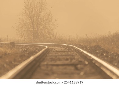 Railway track for engine unit passenger trains in autumn foggy cold morning - Powered by Shutterstock