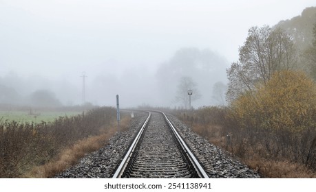 Railway track for engine unit passenger trains in autumn foggy cold morning - Powered by Shutterstock