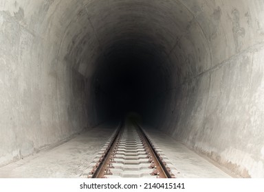 Railway Track Leading Lines Into The Dark Train Tunnel Entrance. Traveling By Train, Space For Text, Selective Focus.