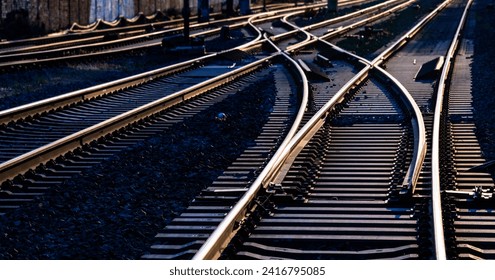 Railway track panorama with high contrast at evening twilight. Reflecting and glistening rails, switches and crossings on main line in Hagen Germany. Technical infrastructure and symbolic background.  - Powered by Shutterstock