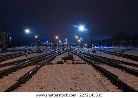 railway tracks, diesel locomotive and railway wagons against the blue sky.