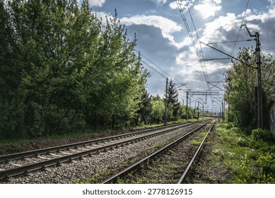 Railway tracks and dramatic cloudy sunset near Kraków Łobzów station in Poland