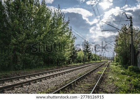Railway tracks and dramatic cloudy sunset near Kraków Łobzów station in Poland