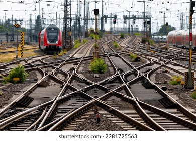 Railway tracks at Frankfurt main station Germany. Complex system of switches, crossings, overhead lines and signals for trains arriving and leaving.