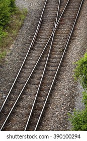 Railway Tracks Junction With Green Plants Along Both Side, Two Paths Come Together