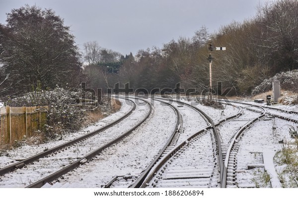 Railway\
tracks in a light sprinkling of sno with signal where th tracks\
divide in Uttoxeter, Staffordshire,\
England