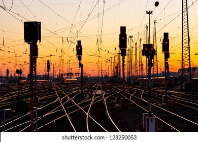 Railway Tracks At A Major Train Station At Sunset.