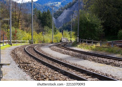Railway tracks at railway station Versam-Safien, Canton Graubünden, on a blue cloudy autumn day. Photo taken September 26th, 2022, Versam-Safien, Switzerland.
