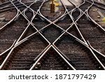 Railway tracks with switches and interchanges at main lines in Frankfurt Germany to various destinations. Symmetry and geometrical structures, lines and high contrast of rails and thresholds  gravel.