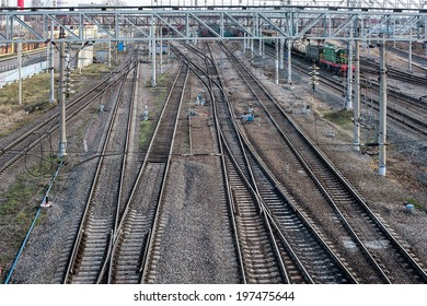 Railway Tracks At A Train Station. Railroad Overhead Lines.