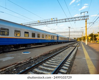 Railway tracks and trains on them. Rails in perspective. - Powered by Shutterstock