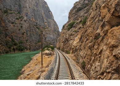 Railway tracks winding through the dramatic Gullubag Canyon beside the Euphrates River in eastern Turkey. This scenic railway corridor is part of the historic route used by the famous Eastern Express.