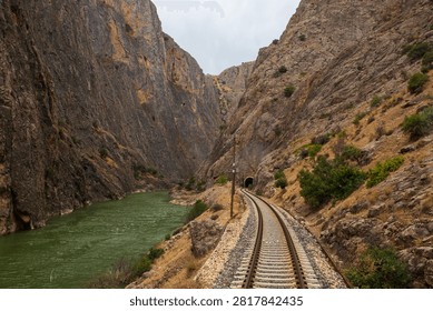 Railway tracks winding through the dramatic Gullubag Canyon beside the Euphrates River in eastern Turkey. This scenic railway corridor is part of the historic route used by the famous Eastern Express.