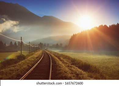 Railway and train in the Alpes at sunrise - Powered by Shutterstock