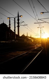 Railway Transport In Istanbul, Turkey. A Modern Tram Stop And Mosque During Sunset