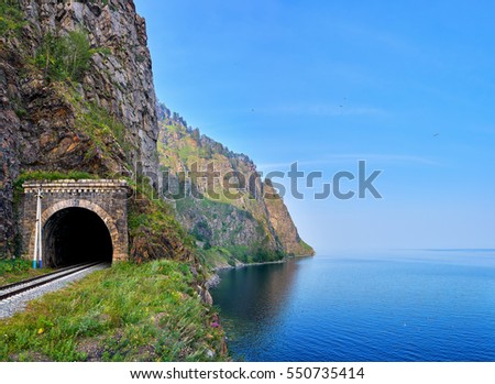 Railway tunnel at edge of land from deepest Lake Baikal. Irkutsk region. Russia