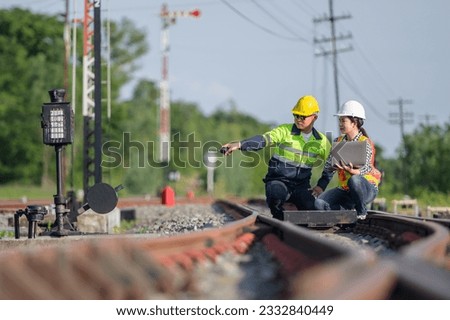 railway worker or engineer who maintains a railway track inspects the switchgear construction process and inspects work at the railway station.