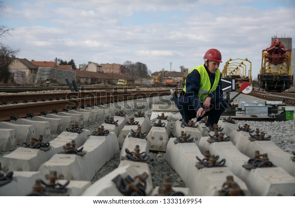 Railway worker on\
railroad construction\
site