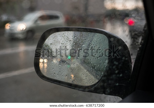 rain behind a window. rain drops on glass. cars on
the road. heavy rain