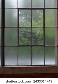 Rain behind window which is composed from two different types of class - clear and matte. 