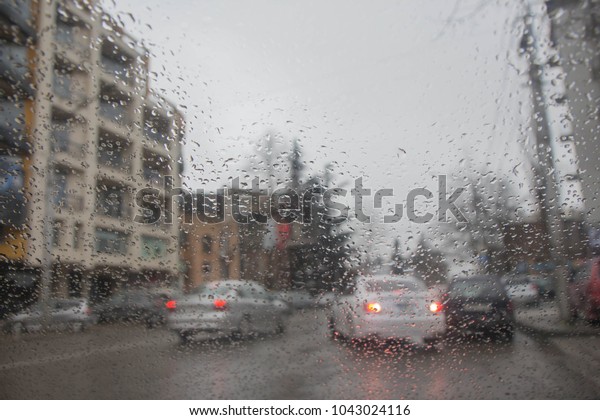 rain and bokeh. Blurry car and Street.\
Drops Of Rain On car windshield, Glass\
Background