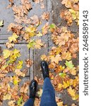 rain boots walking in orange and yellow fall leaves on wet sidwalk in san francisco california
