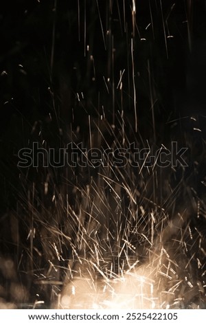 Rain bouncing off a spot light creating an electric effect of sparks flying through the air