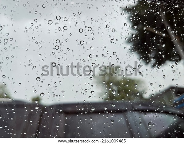 In the rain, car
windshield drops.