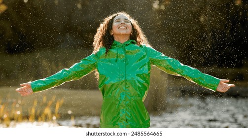 Rain, celebration and happy woman in a park with arms up, gratitude and having fun in nature. Storm, water splash and excited girl person in Mexico with winter dance, adventure and travel freedom - Powered by Shutterstock