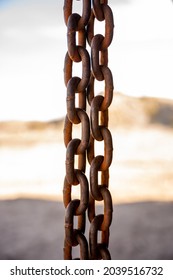 Rain Chains Hang From Desert Building With Blurred Background