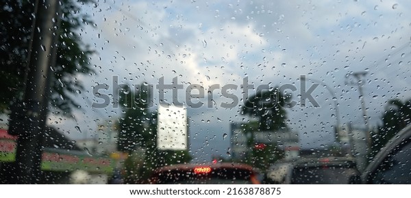 Rain in the City Through\
Glass of Car
