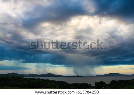 A rain cloud over the sea.