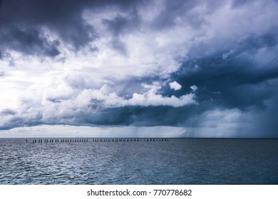 Rain cloud over the sea between the storm and the sunlight Filling lonely and blues.