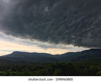 Rain clouds before the Storm . The rain and storm is coming over the mountain we can see the dark and formidable cloud.