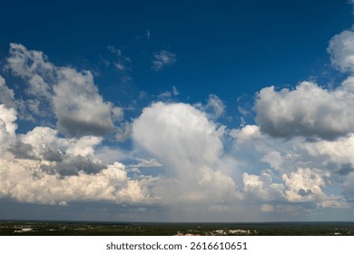Rain clouds forming on blue sky over rural Florida town. Colorful summer skyscape