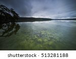 
Rain clouds on the lake,
Reflection of dark clouds in the water,
Clear water in autumn and algae under water,
Watering trees and their reflection