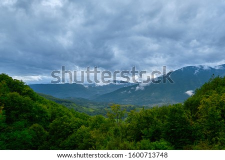Rain clouds over the forested mountains of Central Bosnia, Bosnia and Herzegovina.