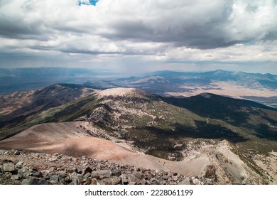 Rain clouds over Great Basin National Park as seen on a summer day from the summit of Wheeler Peak facing north. Stella Lake and Bald Mountain are seen in the distance. Located near Baker, Nevada. 