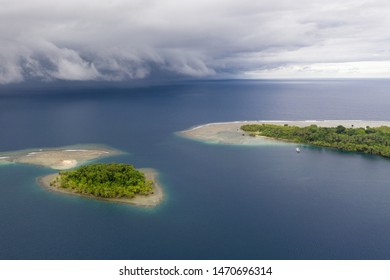 Rain Clouds Sweep Over The Pacific Ocean Approaching Small, Tropical Islands In Papua New Guinea. Squalls Are Common In The Tropics And They Come And Go Quickly.