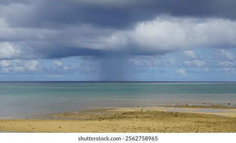 Rain columns from rain clouds floating over the sea. A passing shower, a sign of a squall.