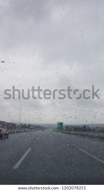 rain\
drop on the car front window and too much\
traffick