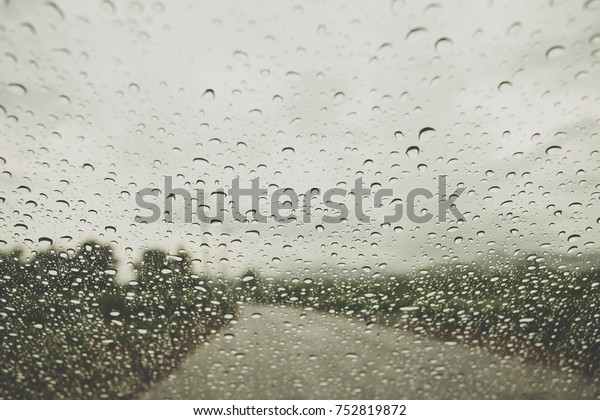 Rain\
drop on the car glass background, vintage color\
tone