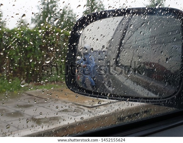 rain drop on car window. blurry\
background car window after rain. water drop on glass.\
