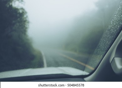 Rain Drop On Glass Of The Car With Fog Or Mist In Green Nature Mountain