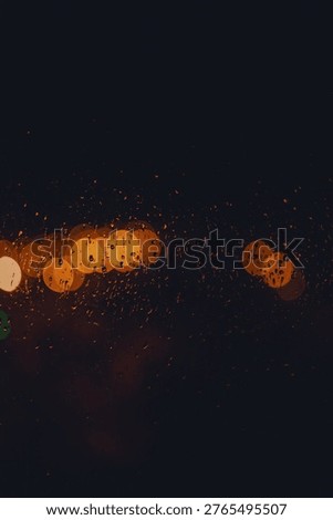 Rain drop on window at night. Outside window is blurred bokeh of raining city light