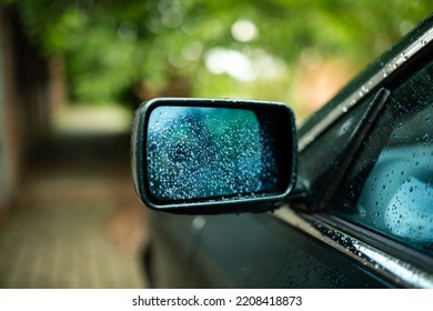 Rain Droplets On A Car's Side Mirror. Close Up Shot, Shallow Depth Of Field, No People