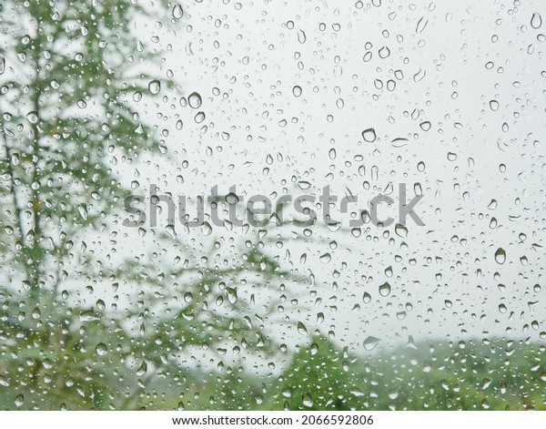 Rain droplets\
on a car\'s window on a rainy day\
