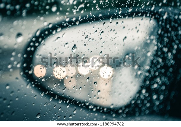 Rain droplets on\
Window looking at Car\
Mirror